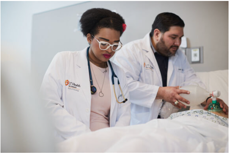 Doctors practicing on dummy patient